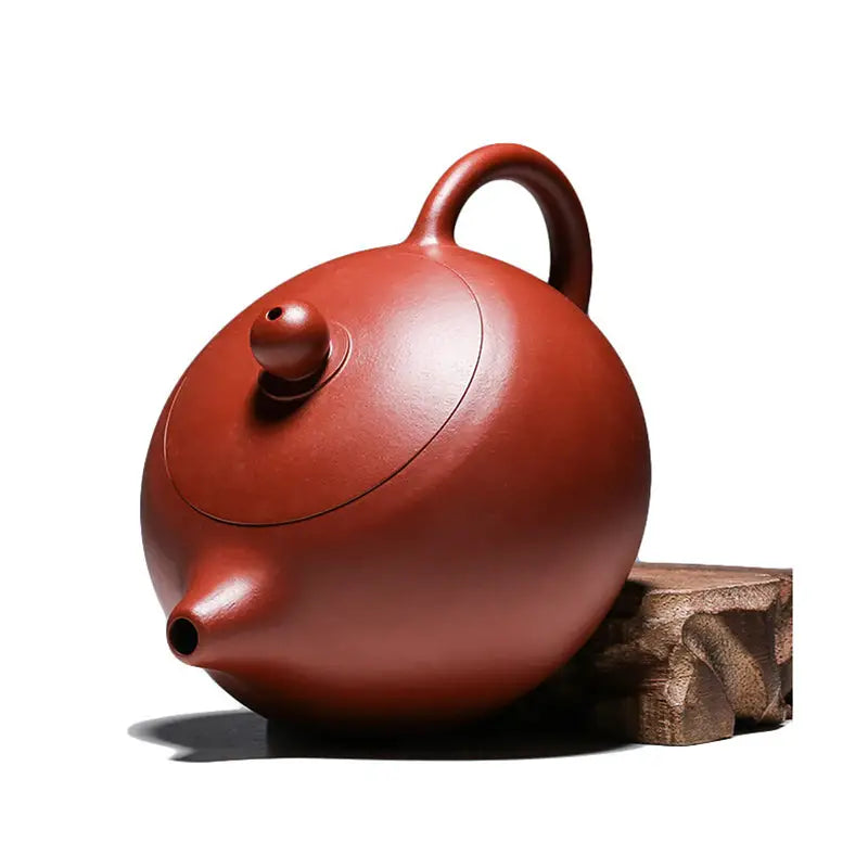 Round reddish-brown handmade Yixing Zisha ceramic teapot from The Still Moon featuring red clay