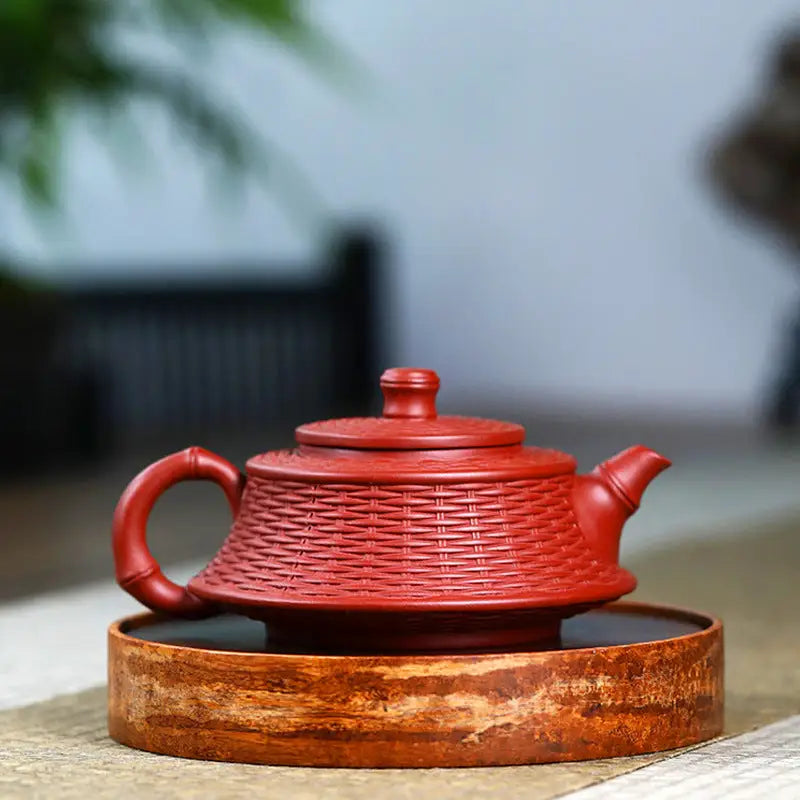 Red woven-texture teapot made from Yixing Zisha clay showcasing The Woven Harmony design