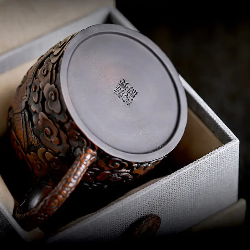 Ornate metal mug with three-dimensional dragon design in jianshui zitao teapots box