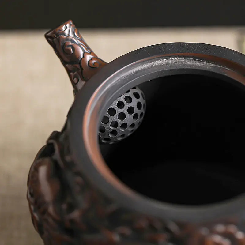Ornate Three-Dimensional Dragon teapot with perforated filter showcasing Jianshui Zitao craftsmanship