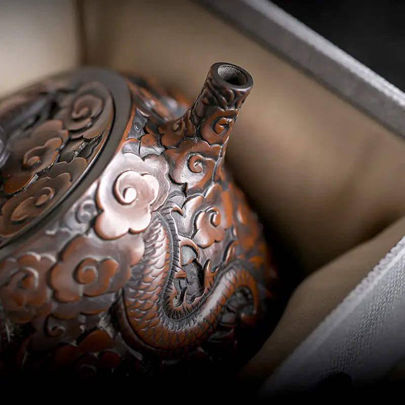 Ornate brown jianshui zitao teapot with three-dimensional dragon and cloud carvings