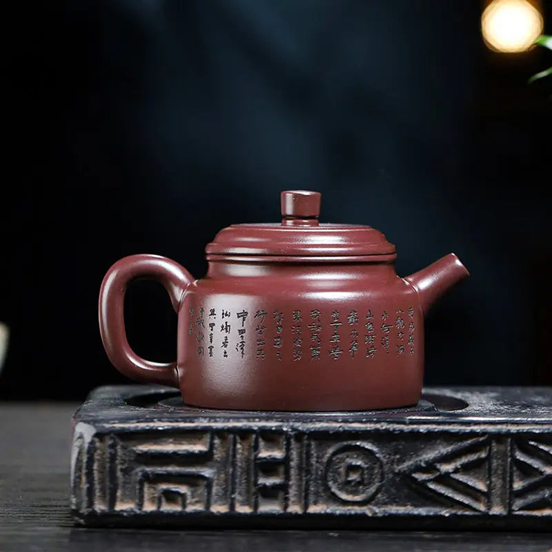 Maroon Yixing Zisha Tidal Horizon teapot with Chinese script for authentic Yixing teapot experience