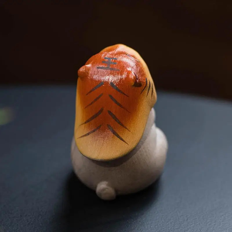 Tanuki figurine with tiger-striped hat from Tiger Spirit Hammy, aYixing tea pet for feng shui tea ritual