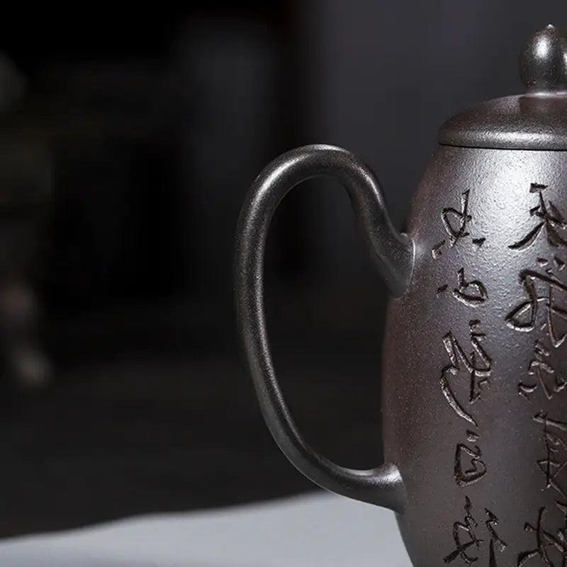 Engraved pewter teapot from Timeless Calligraphy showcasing centuries-old tradition in tall Yixing clay style