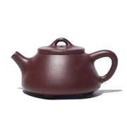 Maroon ceramic Yixing Zisha teapot from Tranquil Loop for Gongfu tea rituals featuring purple clay