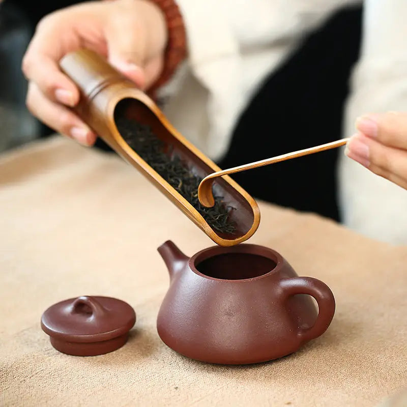 Tea preparation scene with Yixing Zisha teapot and Gongfu tea rituals in purple clay