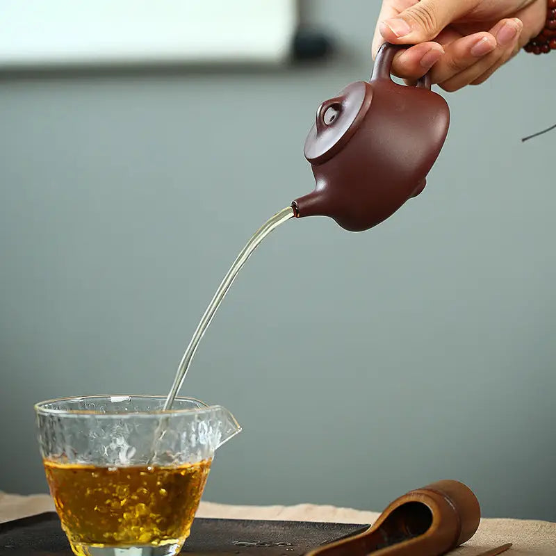 Brown Tranquil Loop Yixing Zisha Teapot pouring tea for Gongfu Tea Rituals