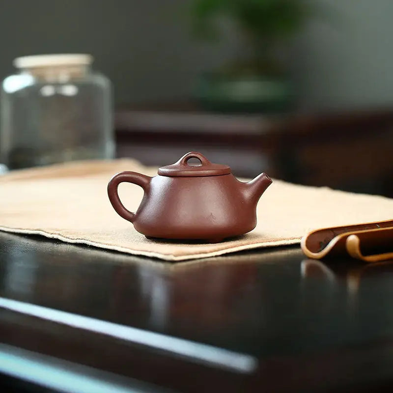 Brown ceramic Yixing Zisha teapot from Tranquil Loop for Gongfu tea rituals in purple clay