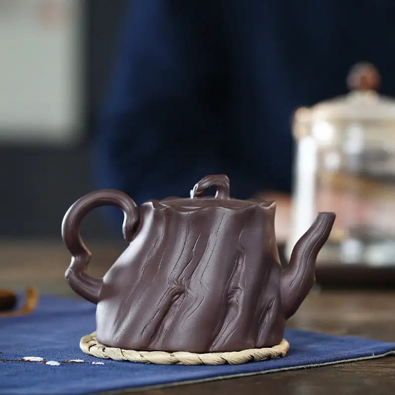 Brown tree-stump-shaped teapot with bark texture, Yixing Zisha craftsmanship, Ginkgo Leaves Yixing design