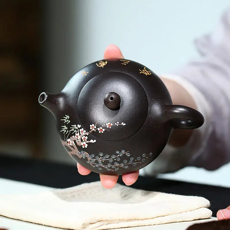 Dark brown Twilight Plum Yixing teapot with hand-painted plum blossoms in black Zisha clay