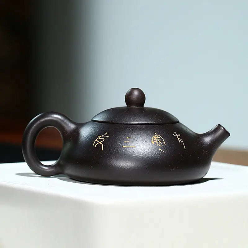 Dark brown ceramic teapot Twilight Plum Yixing with hand-painted plum blossoms in black Zisha clay