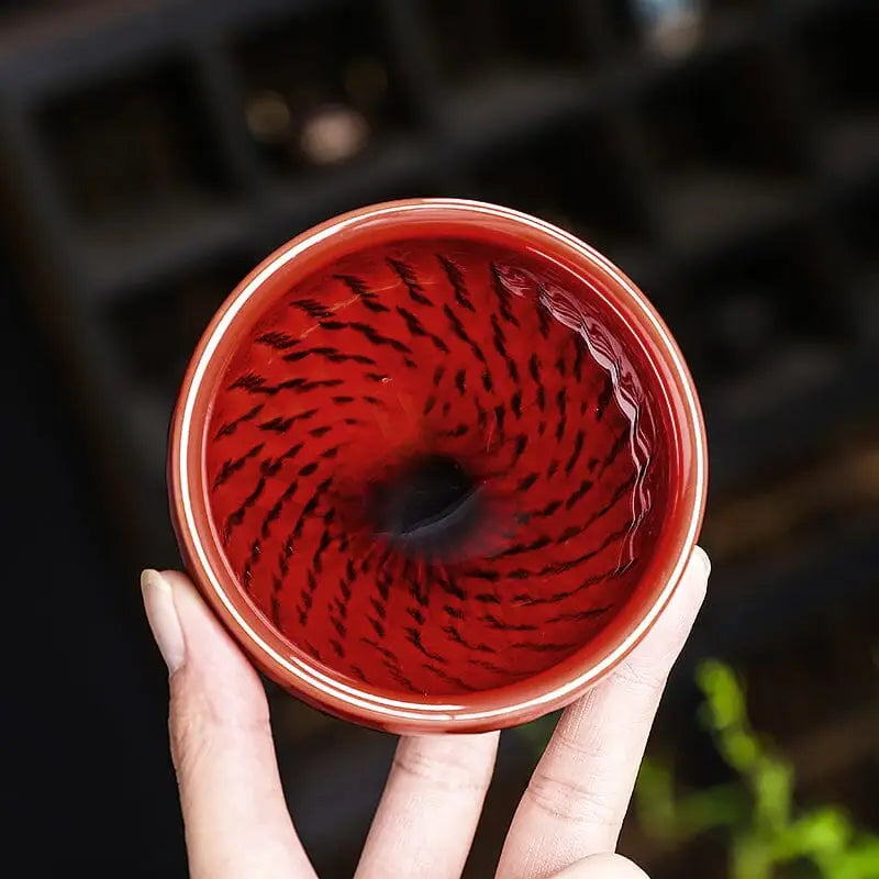 Vampire red ceramic teacup with swirling pattern in bold crimson zhan blood-red glaze