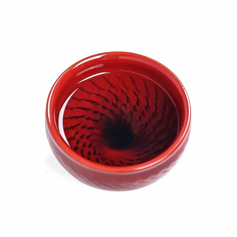 Vampire blood-red glaze teacup with swirling interior, Jian Zhan bold crimson Zhan design