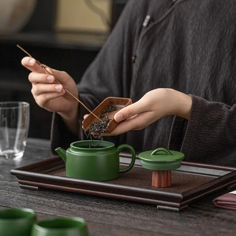 Green ceramic teapot from the Verdant Voyage Tea Set, perfect clay teaware for tea lovers