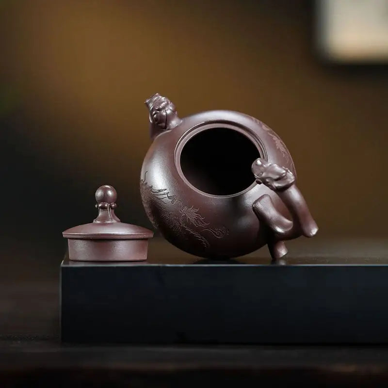 Ornate purple clay Wandering Dragon Yixing Zisha Teapot featuring intricate dragon design