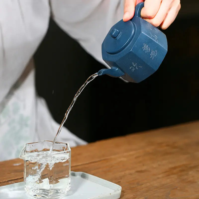 Octagonal blue Yixing teapot from Waves of Mindfulness pouring water in modern minimalism style