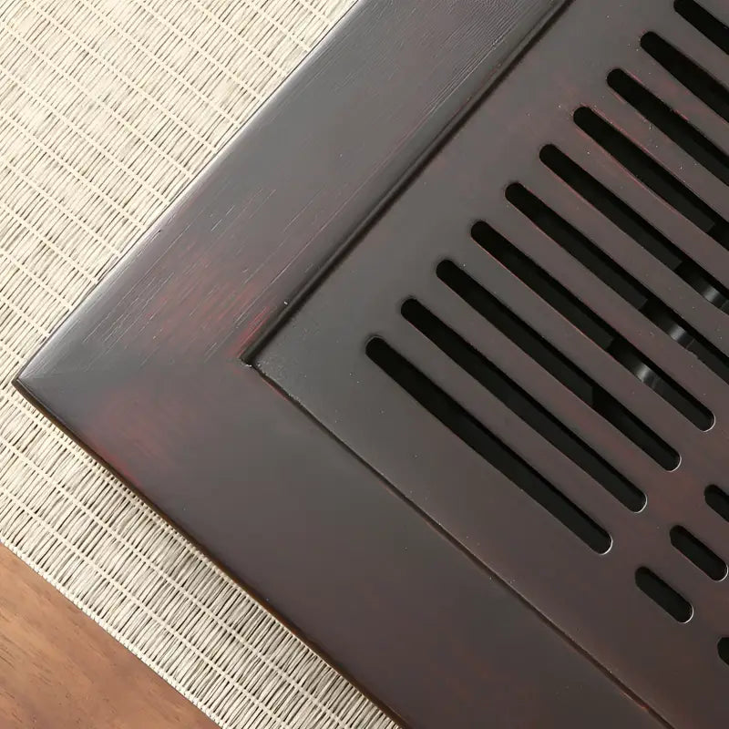 Dark metal grate on Whispering Bamboo Gongfu Tea Tray for authentic tea brewing
