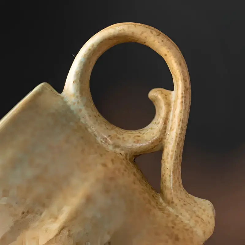 Ceramic coffee cup handle with speckled finish from Whispering Earth Coffee Cup collection