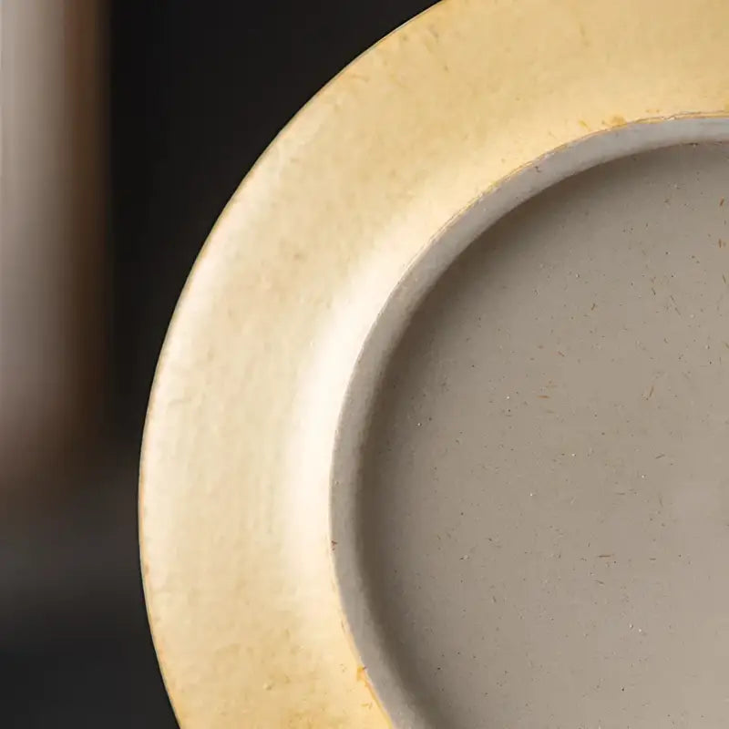 Circular ceramic coffee cup with gold rim from Whispering Earth Coffee Cup collection
