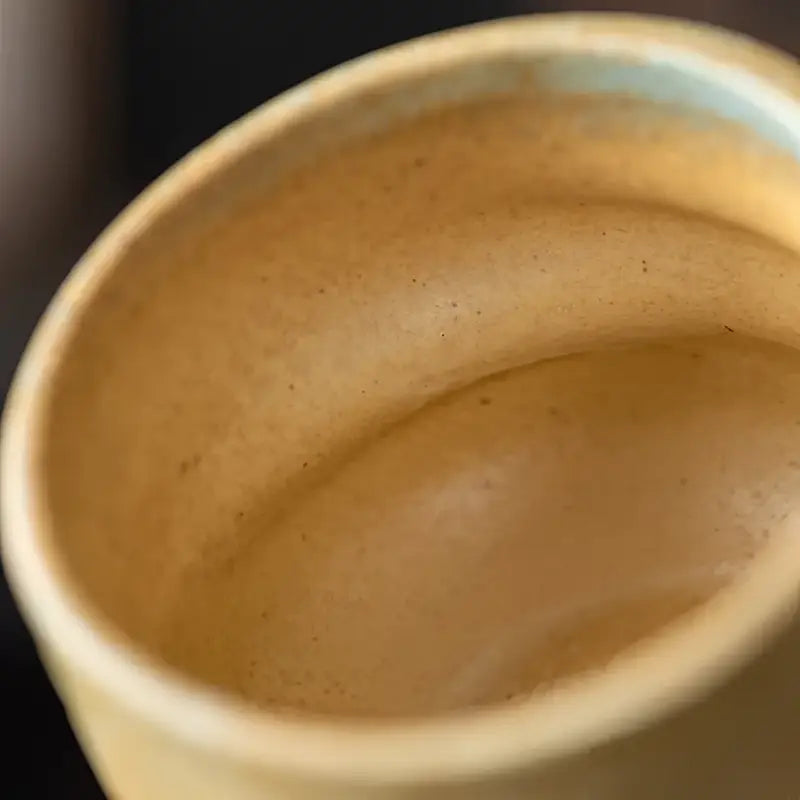 Empty ceramic coffee cup from Whispering Earth Coffee Cup collection