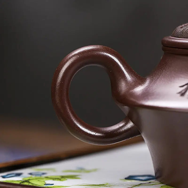 Brown ceramic teapot handle on Whispering Quail Yixing Zisha Yixing Teapot