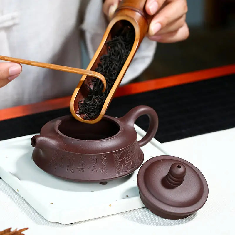 Brown Yixing Zisha teapot with tea leaves from the Whispers of Stillness collection