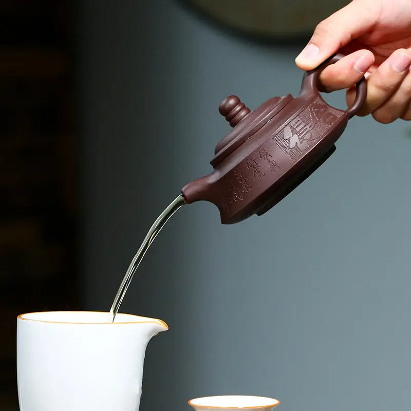 Brown ceramic Yixing Zisha teapot pouring water from the Whispers of Stillness collection