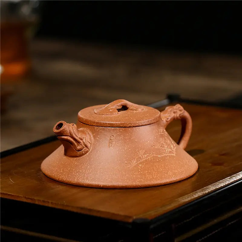 Ornate brown Yixing Zisha teapot from Wind Dragon showcasing traditional Zisha pottery craftsmanship