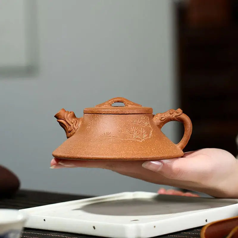Ornate brown Yixing Zisha clay teapot from Wind Dragon, a classic Yixing teapot in Zisha pottery