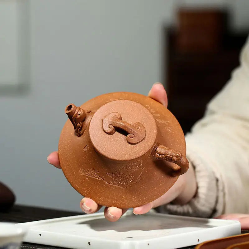 Round brown Yixing Zisha teapot with ornate handle and spout from Wind Dragon