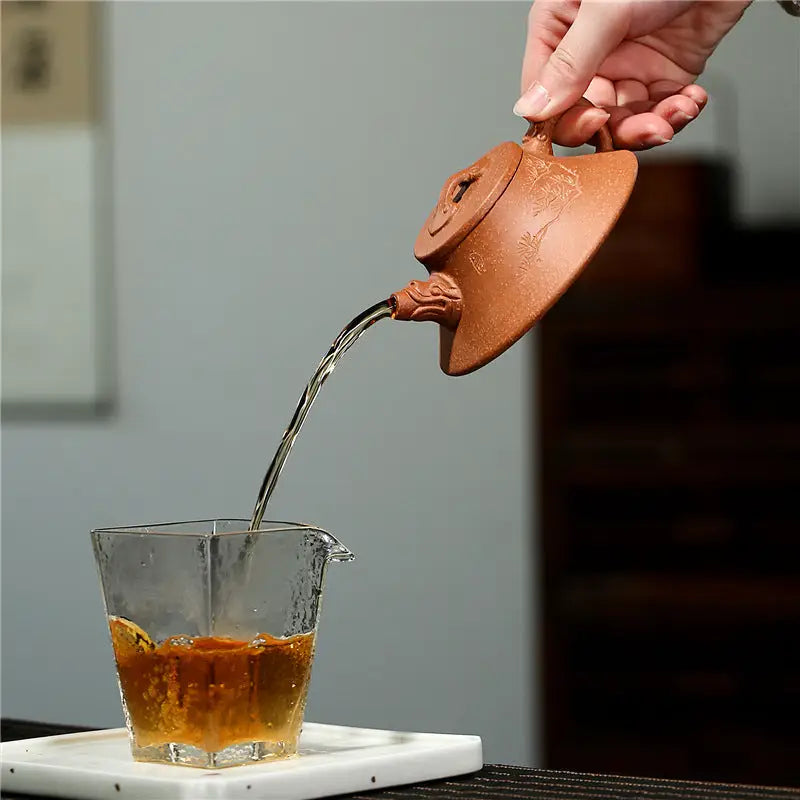 Earthenware Wind Dragon Yixing Zisha Teapot pouring tea showcasing zisha pottery craftsmanship