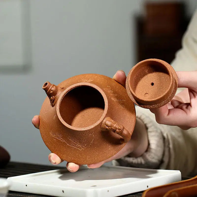 Round brown Yixing Zisha teapot with lid, part of the Wind Dragon Zisha pottery collection