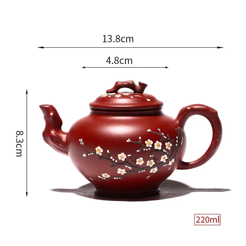 Reddish-brown Yixing teapot with hand-painted plum blossoms in authentic Zisha clay