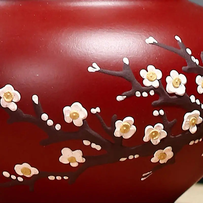 Red vase with floral design from Winter Bloom featuring hand-painted plum blossoms on authentic Zisha clay