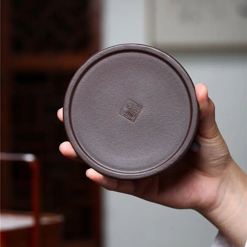 Round brown stamped coaster featuring Wishful Dragon design, perfect for Yixing Zisha Teapot and dragon spout decor