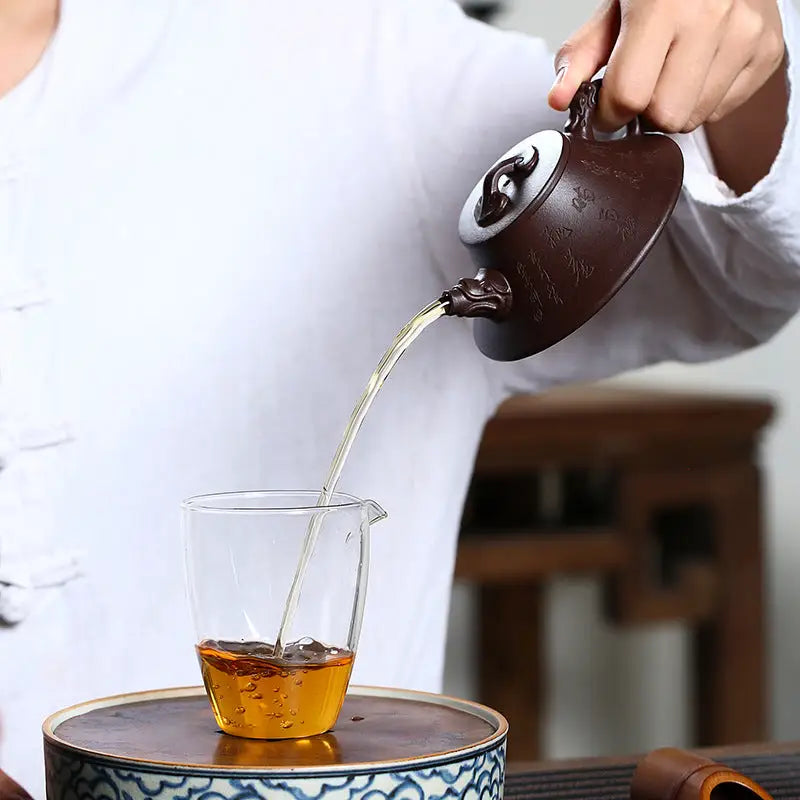 Brown Yixing Zisha Teapot with Dragon Spout pouring tea from Wishful Dragon design