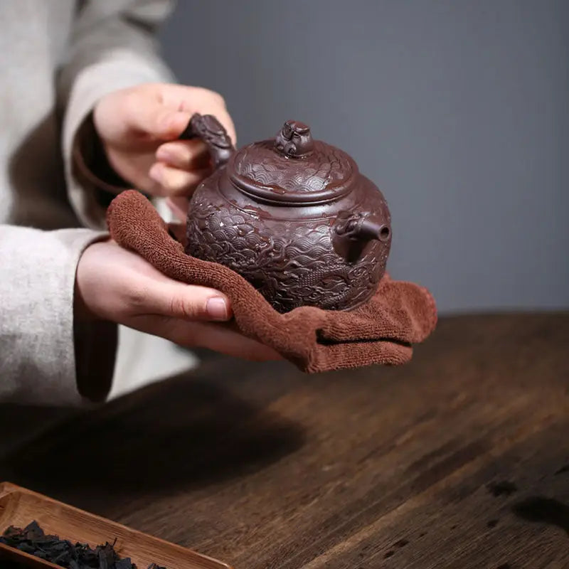 Ornate brown Yixing Zisha teapot on towel from Wishful Dragon collection