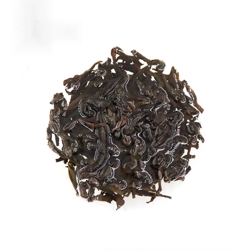 Pile of dark dried Wuyi Rougui tea leaves from traditional roasting for Rougui Rock Tea