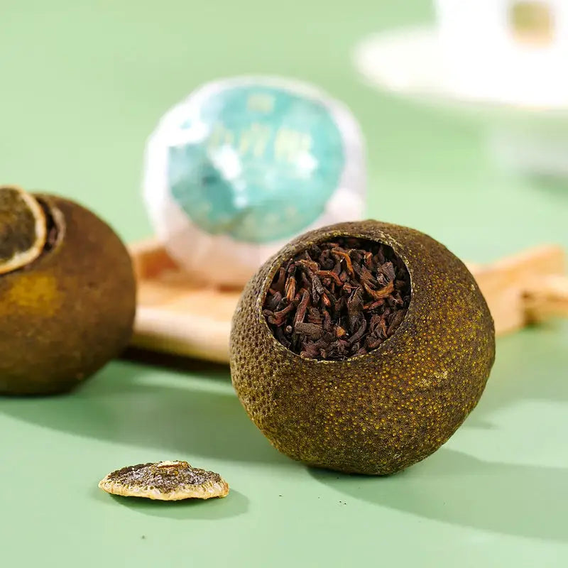 Tea-filled dried citrus fruit for Xiao Qing Gan Pu’er Tea Leaves in teapots and mugs
