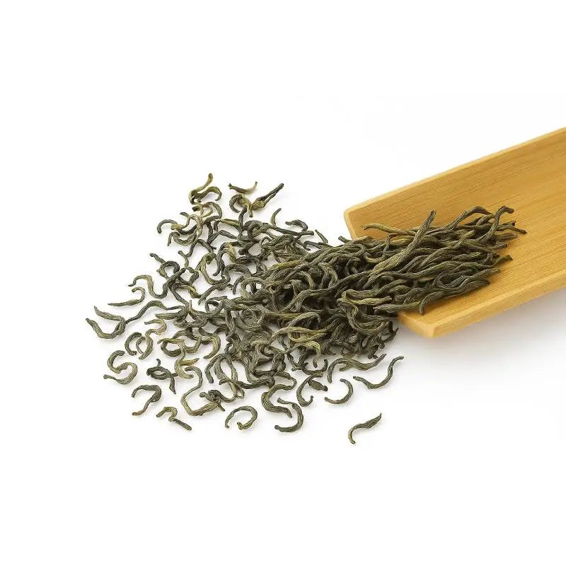 Green tea leaves and bamboo scoop for Yunnan Spring Green Tea with Orchid Fragrance and Bright Liquor