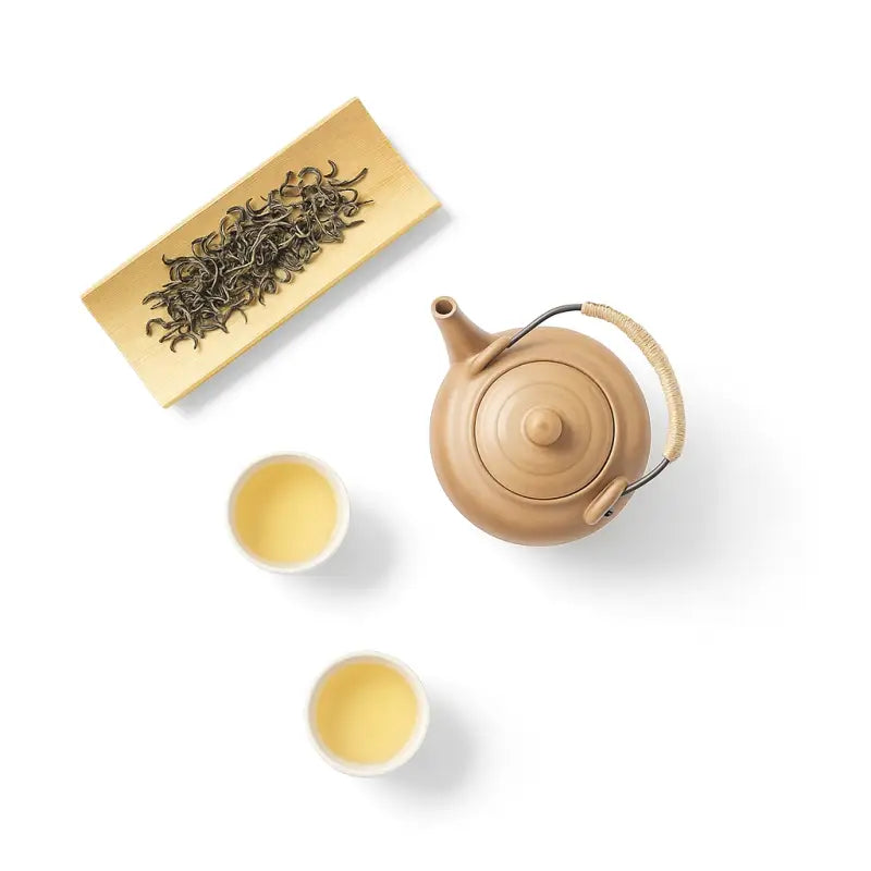 Tea set with loose Yunnan Spring Green Tea leaves and orchid fragrance bright liquor