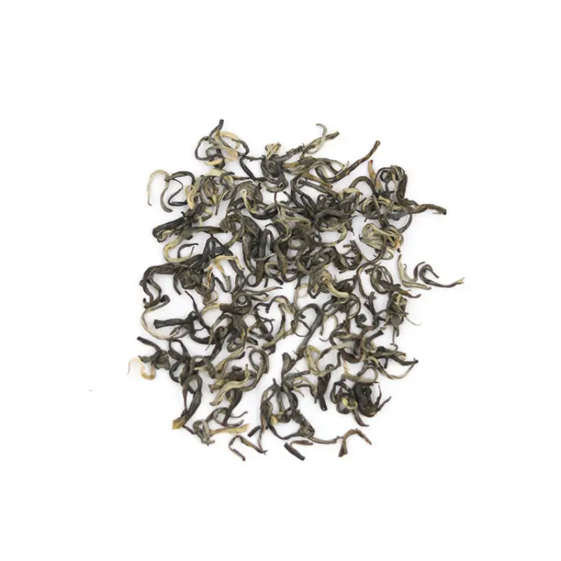 Pile of curled Yunnan Spring Green Tea leaves with orchid fragrance and bright liquor