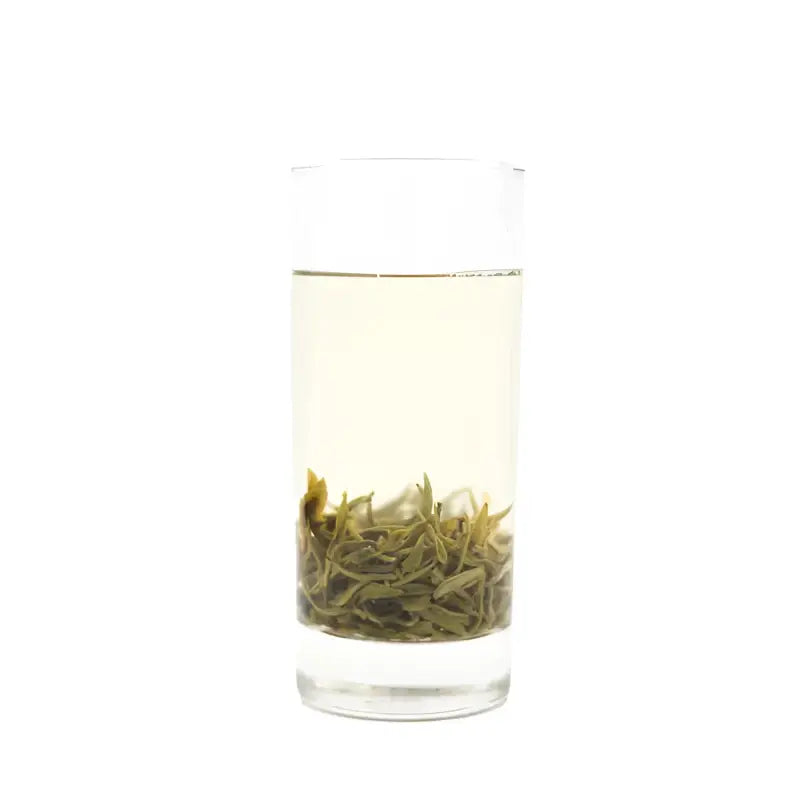 Glass of steeped Yunnan Spring Green Tea with orchid fragrance and bright liquor