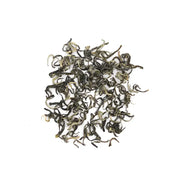 Pile of curled Yunnan Spring Green Tea leaves with orchid fragrance and bright liquor