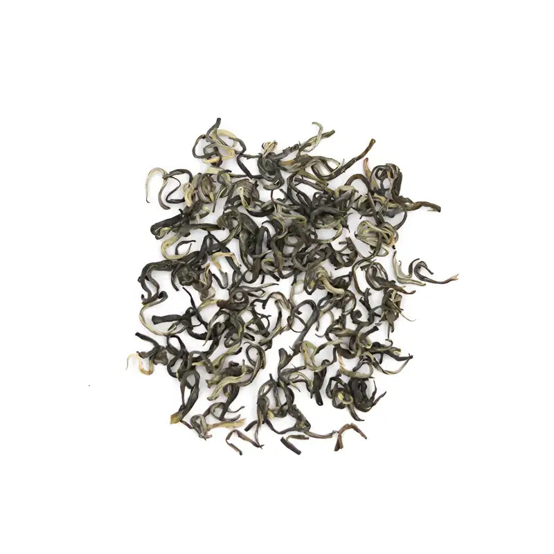 Pile of curled Yunnan Spring Green Tea leaves with orchid fragrance and bright liquor